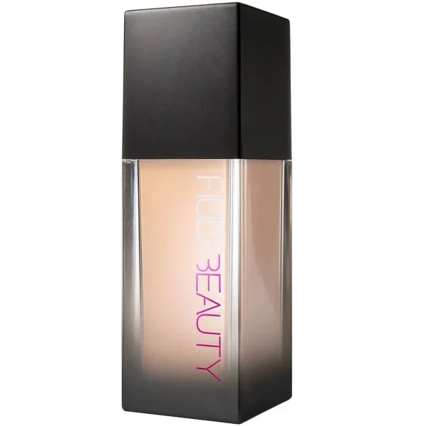 Foundation bottle with a black square cap and beige liquid pink vertical BEAUTY text