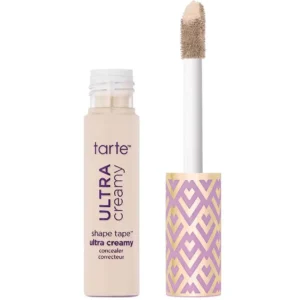 Tarte Ultra Creamy Shape Tape concealer bottle with wand applicator next to it, beige liquid inside.